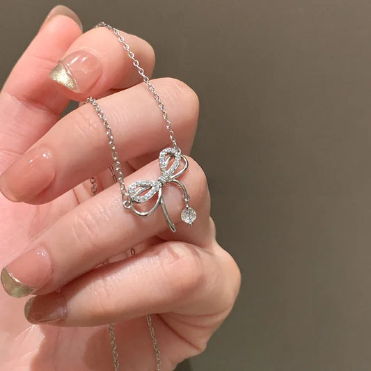 Bowknot Zircon Pendent Necklace. Elegant bowknot zircon pendant necklace in silver finish with sparkling zircon stones, dainty clavicle chain jewelry for women