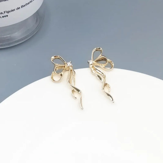 Butterfly Bowknot Earrings in gold with delicate ribbon twist and rhinestone detailing