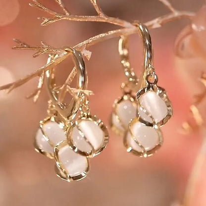 Opal Hoop designer Earrings. Designer opal hoop earrings with gold finish, elegant stone drop hoops featuring luminous opal stones for women