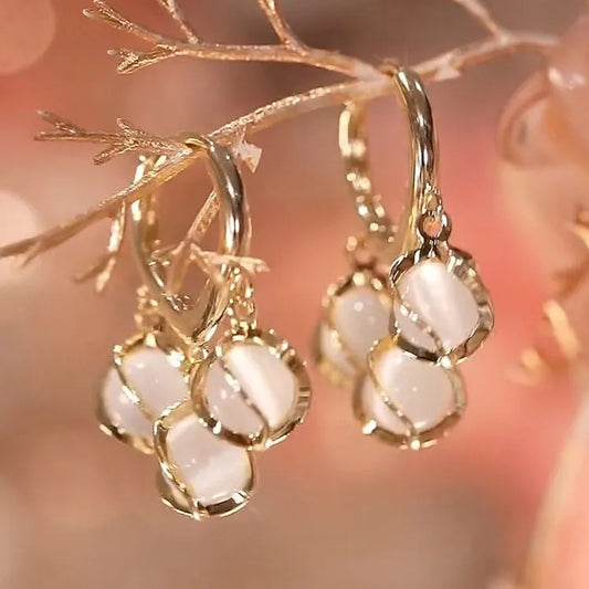 Opal Hoop designer Earrings. Designer opal hoop earrings with gold finish, elegant stone drop hoops featuring luminous opal stones for women
