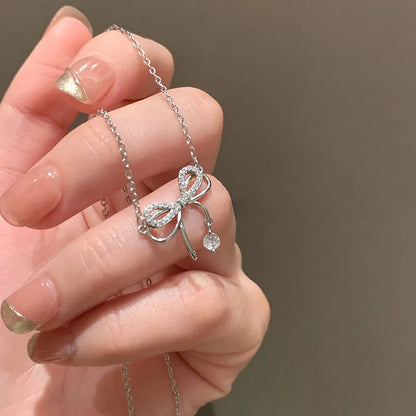 Bowknot Zircon Pendent Necklace. Elegant bowknot zircon pendant necklace in silver finish with sparkling zircon stones, dainty clavicle chain jewelry for women