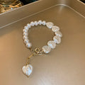 Handmade white beaded bracelet with heart-shaped pearls and gold charm for women