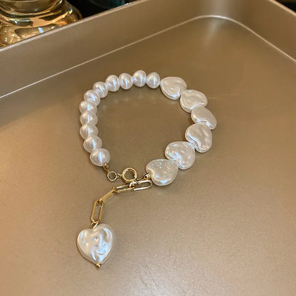 Handmade white beaded bracelet with heart-shaped pearls and gold charm for women