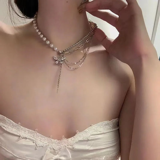 Woman wearing elegant pearl butterfly choker necklace with tassel layered design jewellery India