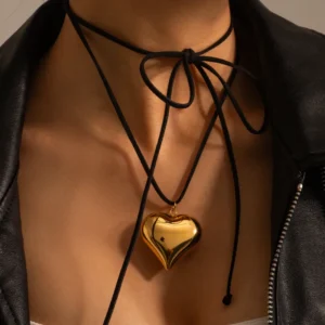 18K gold plated heart pendant necklace on black rope choker worn by a woman